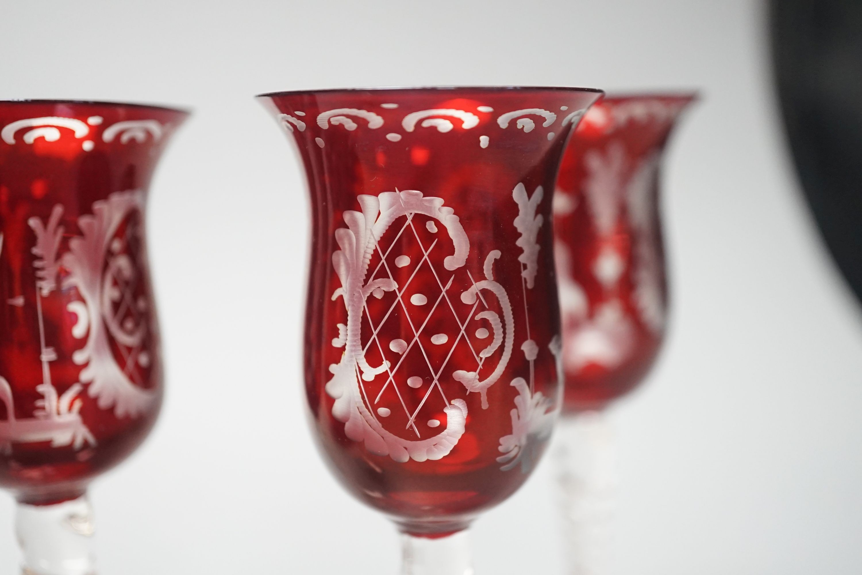 A Bohemian wheel engraved ruby flashed glass decanter and four matching liqueur glasses